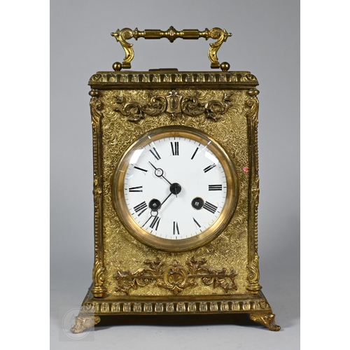 677 - A Continental profusely-chased brass mantel clock, the 8-day two train movement striking the hours a... 