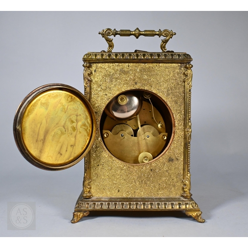 677 - A Continental profusely-chased brass mantel clock, the 8-day two train movement striking the hours a... 