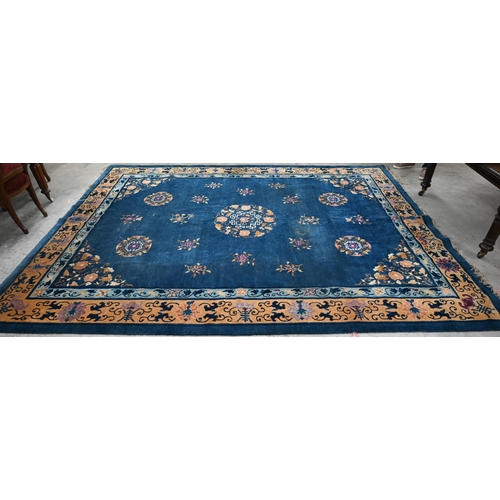 592 - A Mid-Century Chinese Peking carpet, scattered design with floral sprays and roundels on blue ground... 