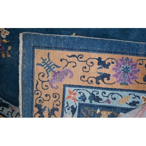 592 - A Mid-Century Chinese Peking carpet, scattered design with floral sprays and roundels on blue ground... 