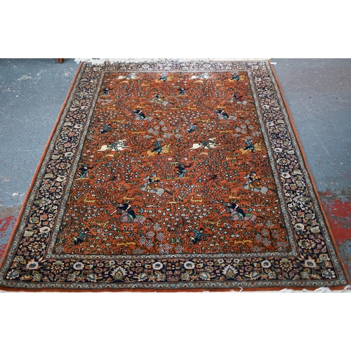 594 - A Persian Quom rug, mid 20th century, the brown-gold ground with pictorial hunting scenes intertwine... 