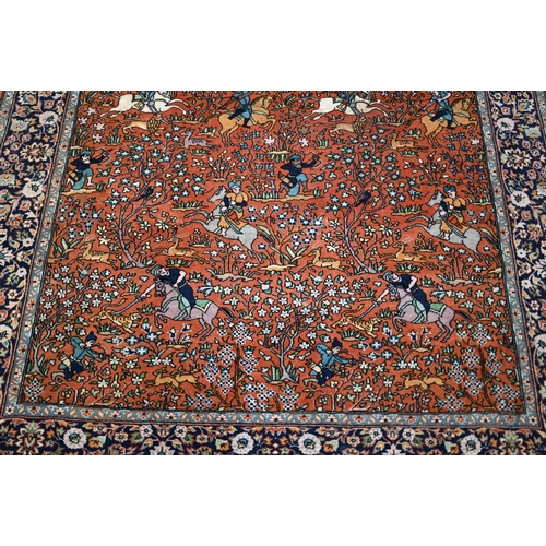 594 - A Persian Quom rug, mid 20th century, the brown-gold ground with pictorial hunting scenes intertwine... 