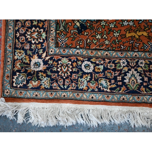 594 - A Persian Quom rug, mid 20th century, the brown-gold ground with pictorial hunting scenes intertwine... 