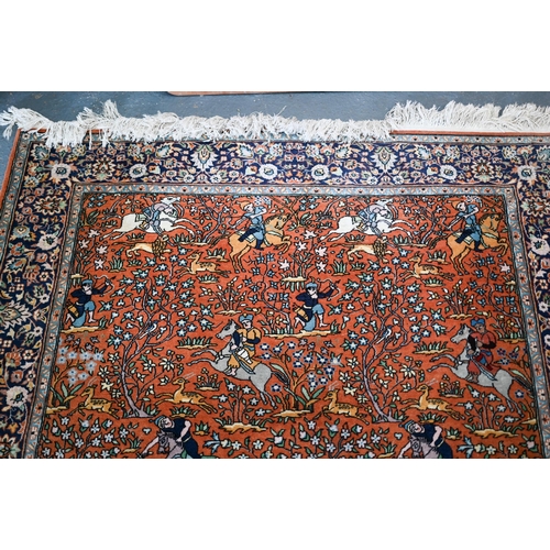 594 - A Persian Quom rug, mid 20th century, the brown-gold ground with pictorial hunting scenes intertwine... 