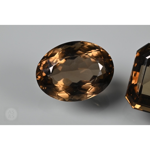 538 - Two loose brown citrine stones, one oval 2 x 1.5 cm, one rectangular 2.2 x 1.8 cm, a pair of pale br... 