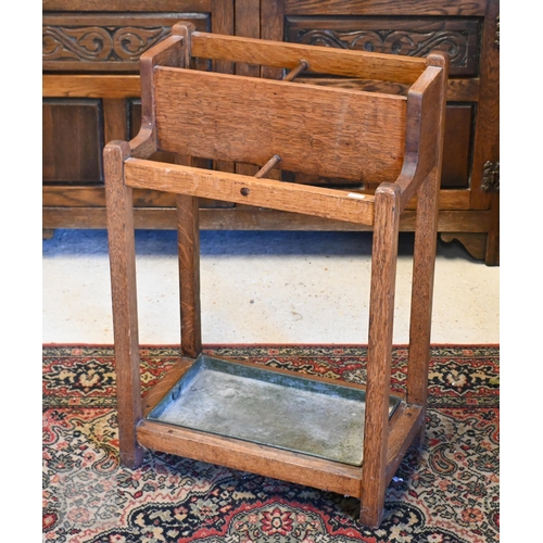 252 - #An early 20th century four division stick stand with metal tray, 46 x 28 x 70 cm high to/w oak fram... 