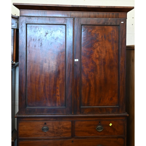 278 - A 19th century figured mahogany linen press (slides replaced by rail), with panelled doors over two ... 