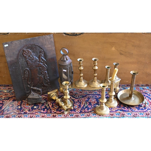 394 - A Victorian brass footman on cabriole supports and an antique oak panel carved with a heraldic Royal... 