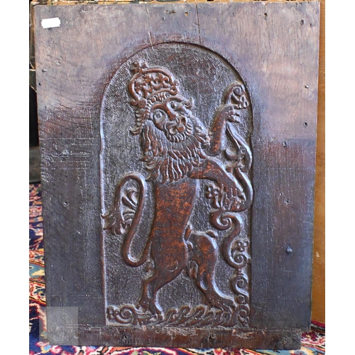 394 - A Victorian brass footman on cabriole supports and an antique oak panel carved with a heraldic Royal... 