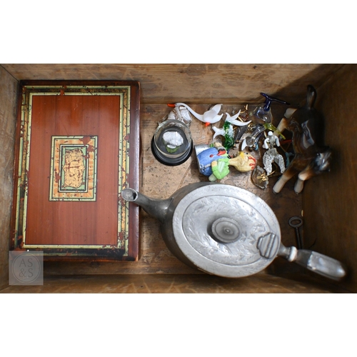 557 - A vintage wooden ditty box and contents including cast metal 'dog' nutcrackers, glass miniature anim... 