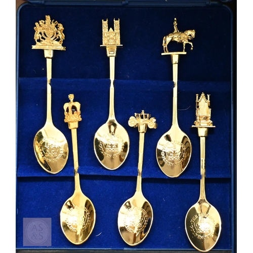 557 - A vintage wooden ditty box and contents including cast metal 'dog' nutcrackers, glass miniature anim... 