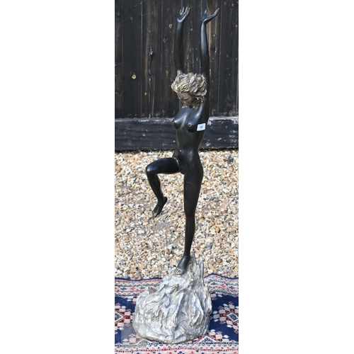 568 - A large bronzed figure of a nude dancer with arms raised, 110 cm high
