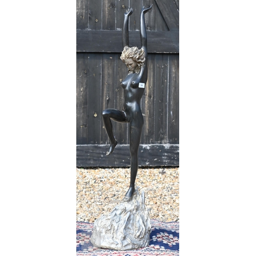 568 - A large bronzed figure of a nude dancer with arms raised, 110 cm high