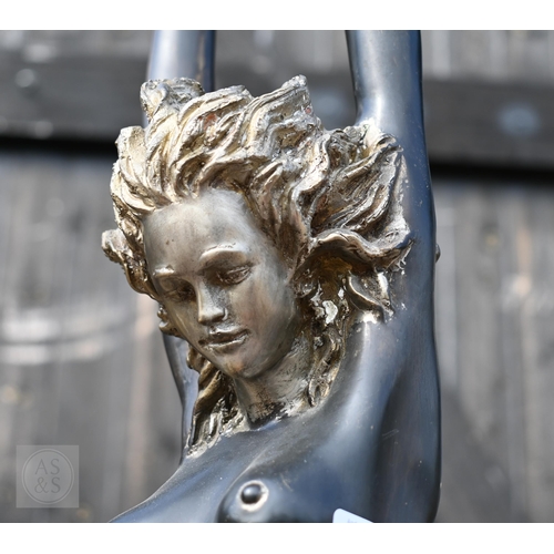 568 - A large bronzed figure of a nude dancer with arms raised, 110 cm high