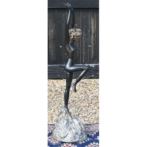 568 - A large bronzed figure of a nude dancer with arms raised, 110 cm high