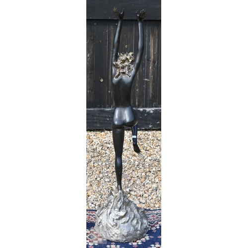 568 - A large bronzed figure of a nude dancer with arms raised, 110 cm high