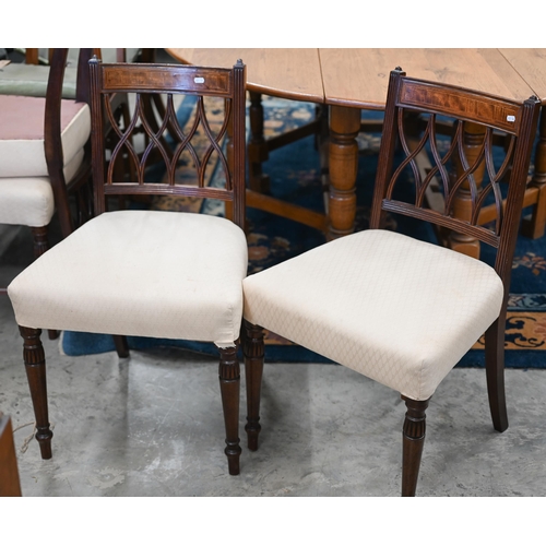 578 - A set of four Edwardian mahognay lattice back dining chairs, overstuffed with pale pink diamond patt... 