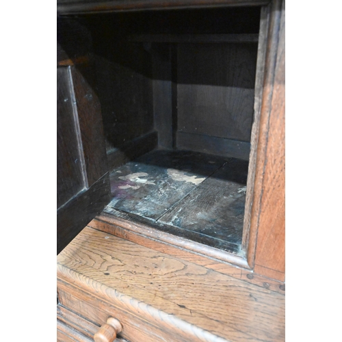 583 - An 18th century and later oak tridarn with two drawers and panelled cupboard doors, 134 x 60 x 210 c... 