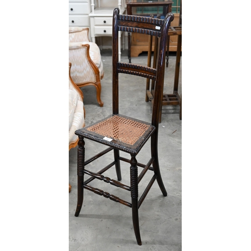 587 - A Victorian stained beech cane seated correction chair on turned legs