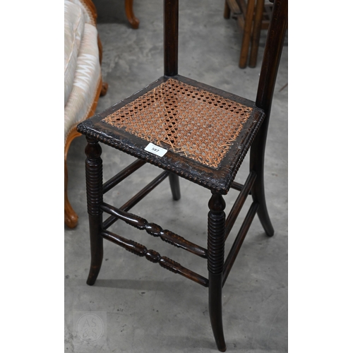 587 - A Victorian stained beech cane seated correction chair on turned legs