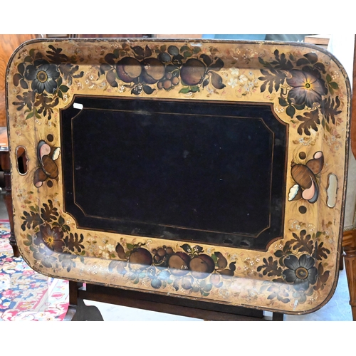 588 - A black metal folding tray-top table with gilt and polychrome flowers and fruit decoration