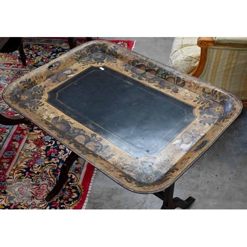 588 - A black metal folding tray-top table with gilt and polychrome flowers and fruit decoration