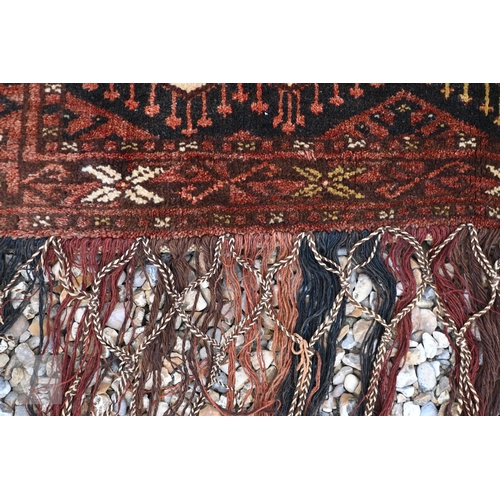 597 - A vintage Turkoman Beshir/Esari tent hanging with geometric design on brown/blue ground, 124 x 51 cm