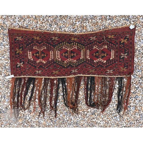 597 - A vintage Turkoman Beshir/Esari tent hanging with geometric design on brown/blue ground, 124 x 51 cm