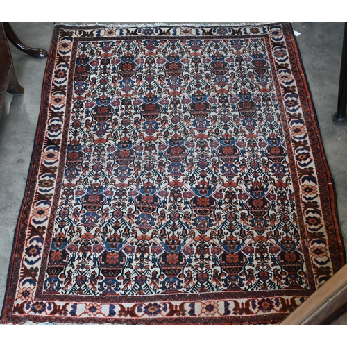 599 - A vintage Persian Balouch rug with tessalating octagonal motif on red ground, 176 x 96 cm to/w a Per... 