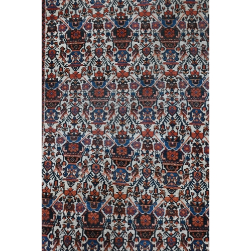 599 - A vintage Persian Balouch rug with tessalating octagonal motif on red ground, 176 x 96 cm to/w a Per... 