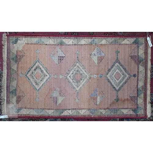 601 - A Turkish Milas cream ground rug with floral diamond medallions and yellow border, 182 x 121 cm to/w... 