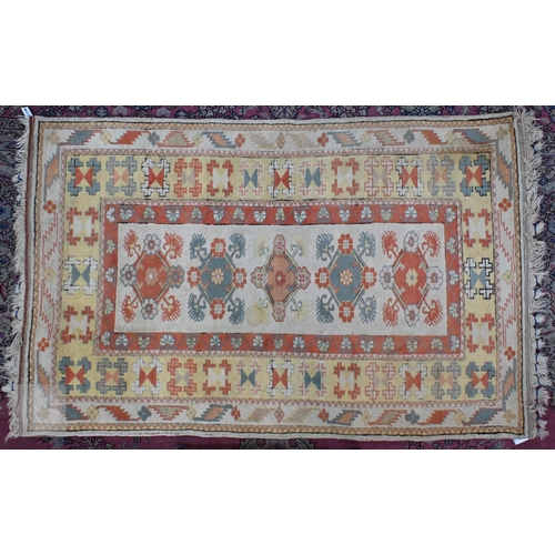 601 - A Turkish Milas cream ground rug with floral diamond medallions and yellow border, 182 x 121 cm to/w... 