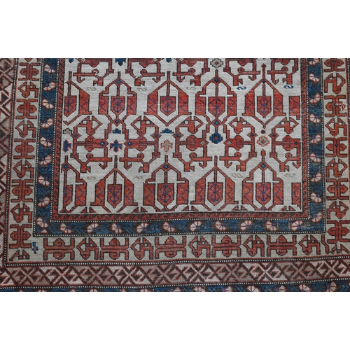 605 - An antique Persian Shirvan rug, beige ground with blue borders, 134 x 99 cm