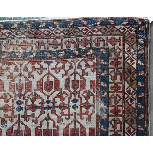 605 - An antique Persian Shirvan rug, beige ground with blue borders, 134 x 99 cm