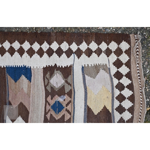 609 - A vintage Afghan Kelim rug with geometric banded design and diamond border, 299 x 142 cm