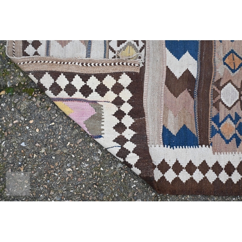 609 - A vintage Afghan Kelim rug with geometric banded design and diamond border, 299 x 142 cm