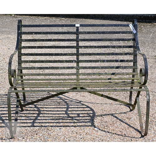 7 - A traditional Victorian style wrought iron two seat bench, 112 cm long