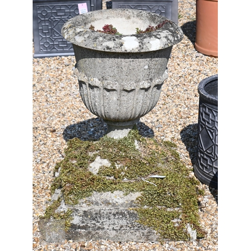 8 - A large weathered reconstituted stone garden tub planter raised on a stepped square plinth base, 73 ... 