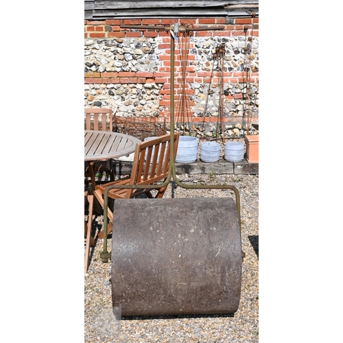 9 - A weathered vintage cast iron garden roller