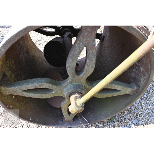 9 - A weathered vintage cast iron garden roller