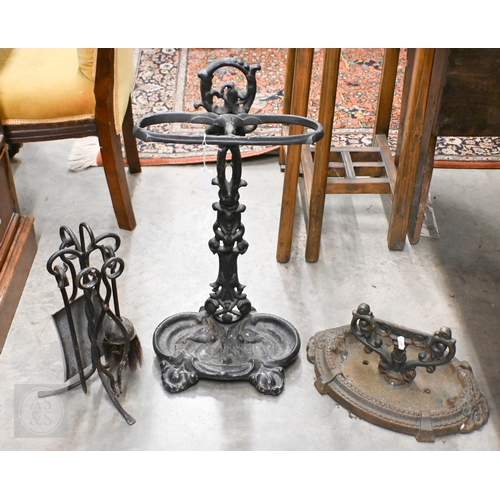 393 - A Victorian cast iron boot-scraper, to/w a stick-tand and a fireside companion set (3)