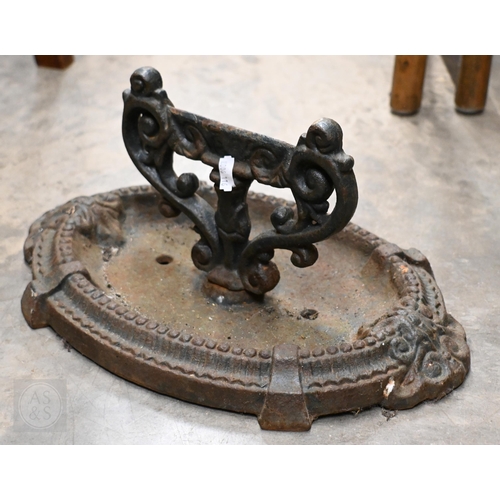 393 - A Victorian cast iron boot-scraper, to/w a stick-tand and a fireside companion set (3)