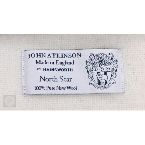 573 - A selection of pink and cream woollen cellular and solid weave blankets, some with satin edging, var... 