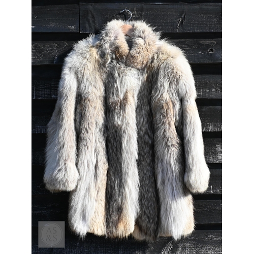 574 - A fur-timmed reversible long coat in black to/w a mid length fox fur jacket (2)