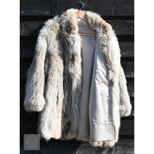 574 - A fur-timmed reversible long coat in black to/w a mid length fox fur jacket (2)