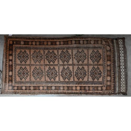 589 - An antique Perisian rug with geometric design, to/w an Afghan double saddle bag (2)