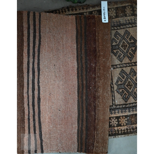 589 - An antique Perisian rug with geometric design, to/w an Afghan double saddle bag (2)
