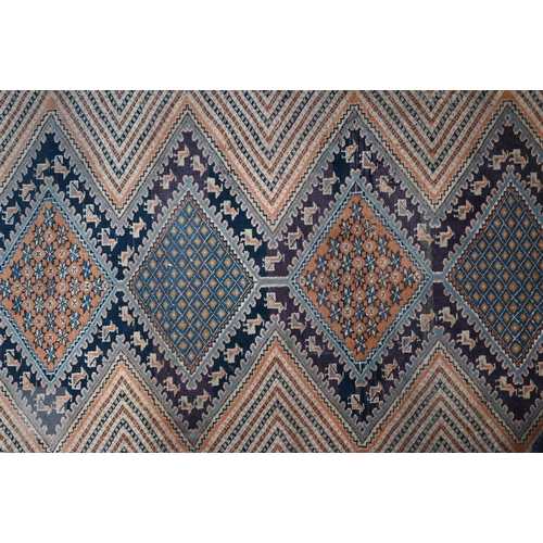 589 - An antique Perisian rug with geometric design, to/w an Afghan double saddle bag (2)