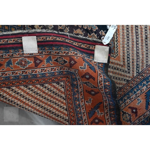 589 - An antique Perisian rug with geometric design, to/w an Afghan double saddle bag (2)