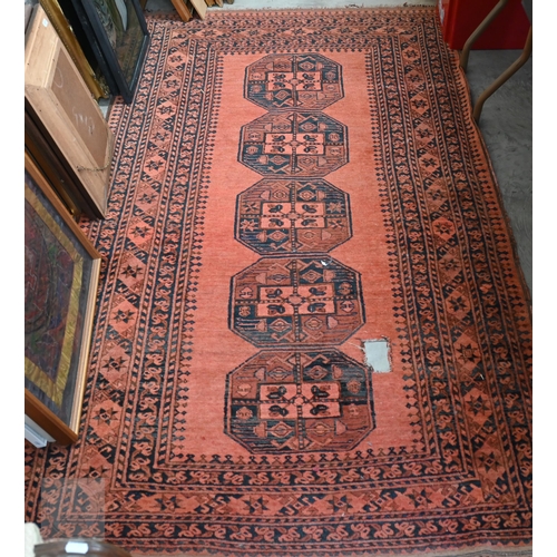 591 - An old Afghan rug with five medallions on pale red ground, 209 x 120 cm
